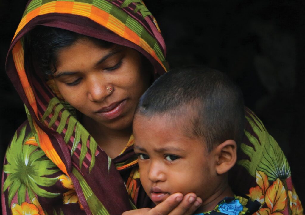 A Minnesota woman holding a child in her arms considers an Order for Protection