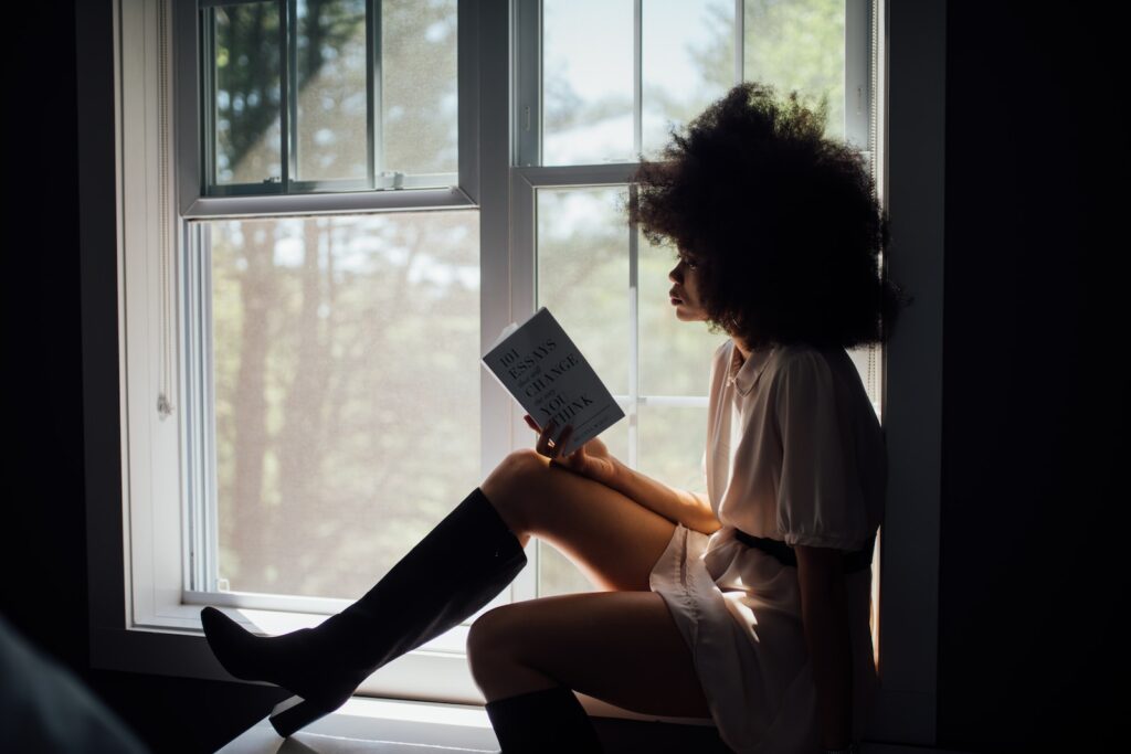 Domestic Violence survivor in Minnesota white top holding book