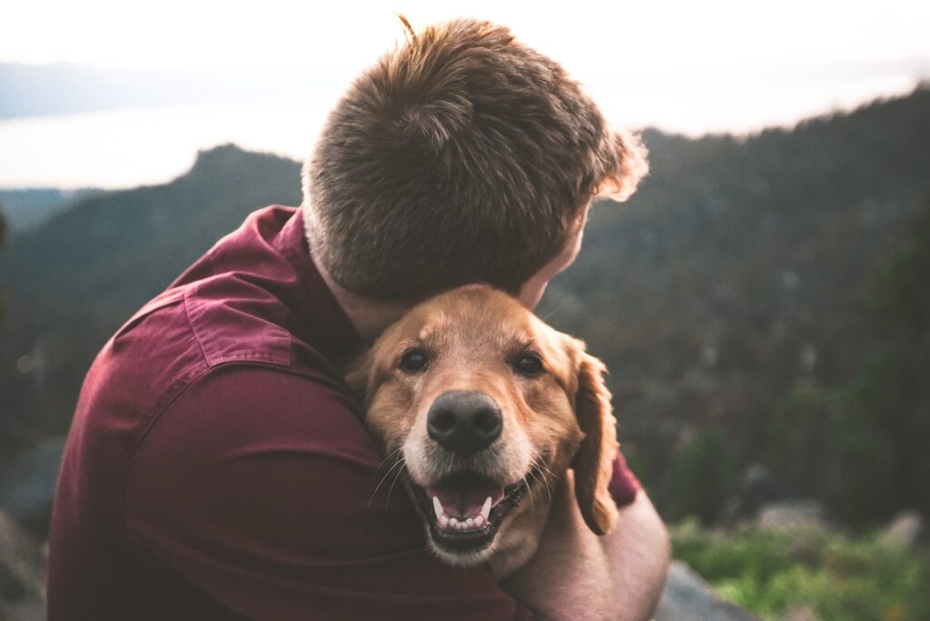 Photo of Minnesota man protecting his pet by hugging his dog