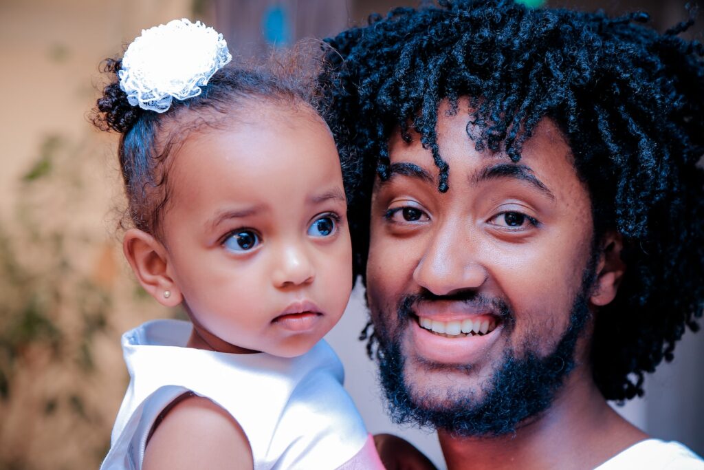 Minnesota man in white top holding  protecting kid from domestic violence